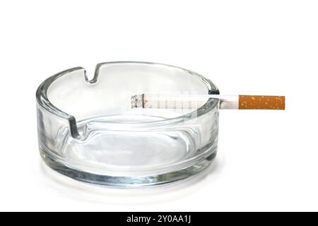 Filter cigarette in an ashtray made of glass, isolated on a white background Stock Photo