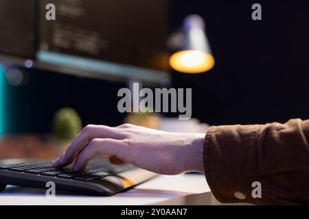 Programmer implementing and maintaining security measures to protect company systems and data. Admin writing, testing and debugging Java code for web and mobile applications, close up Stock Photo