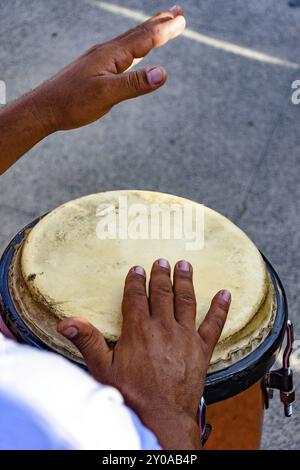 Drum player playing atabaque during presentation of afro music on the eve of the Brazilian carnival Stock Photo