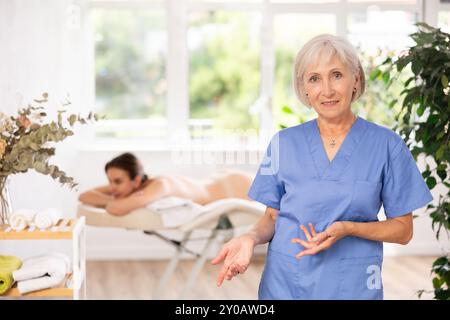 Elderly woman masseuse posing in spa salon Stock Photo