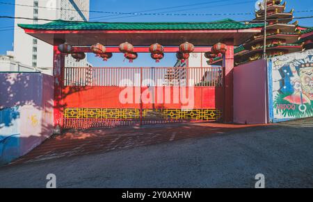 Balikpapan, Indonesia - June 22nd, 2024. the iron gate of Setya Dharma is painted in red and decorated with red lanterns. Stock Photo