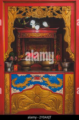 Balikpapan, Indonesia - June 22nd, 2024. A captivating image of a Chinese temple altar, featuring a variety of offerings and statues of Chinese deitie Stock Photo