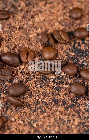 Roasted coffee beans lie together with chocolate crumbled into small pieces, fragrant coffee together with chocolate crumbs Stock Photo