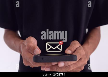Man holding a smartphone with email notification, new message or social media notification. Stock Photo