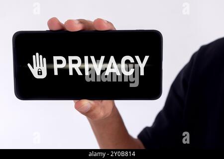 Privacy concept of private data. Man holding a smartphone with privacy written on screen. Stock Photo