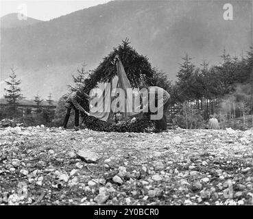 Survivors place a wreath at the site of a mass grave in the Ebensee concentration camp.Ebensee was a subcamp of Mauthausen concentration camp built by the SS in 1943 to build tunnels for armaments storage near the town of Ebensee, Austria. Though the Mauthausen complex was not an extermination centre abuse, cruelty and neglect were commonplace. Between 8,500 and 11,000 prisoners died in the camp, mostly from hunger or malnutrition. The US Army liberated the camp on 6 May 1945. The photo is dated 7th may 1945, the day after liberation. Stock Photo