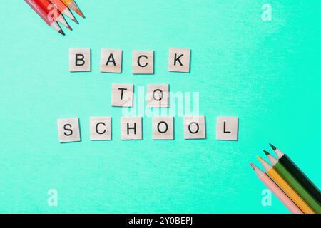 Flat lay, bright back to school concept on blue background. Stock Photo
