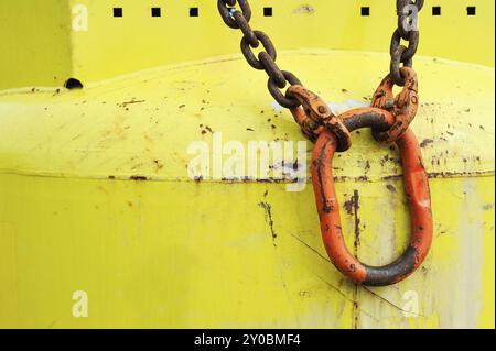 Red carabiner on yellow bottle Stock Photo