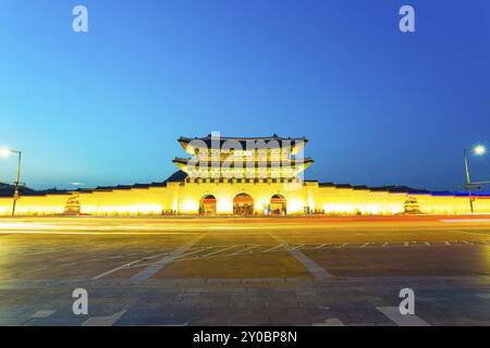 Long exposure car lights leaving a straight light trail in front of Gwanghwamun main entrance gate to Gyeongbokgung Palace in historic part of downtow Stock Photo