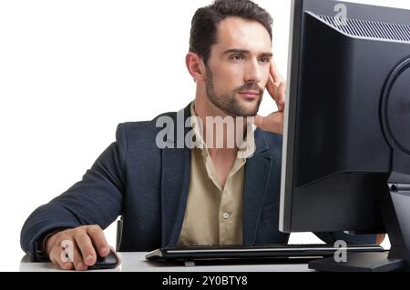 Man looking at a computer screen, thinking about the job at hand Stock Photo
