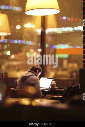 Blurred man with laptop at cafe background, business, technology concept Stock Photo