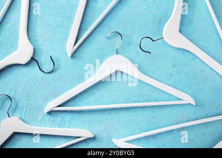 Fashion collection concept. White wooden hangers, a flat lay layout on blue. Shopping background, abstract design, Food photography Stock Photo