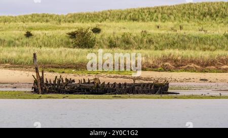 Old Shipwreck on the shore of the River Coquet in Amble, Northumberland, England, UK Stock Photo