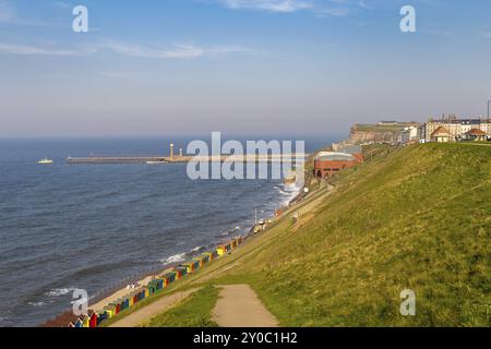 Whitby, North Yorkshire, England, UK, May 08, 2016: View over the Whitby skyline, the beach huts and the pier, seen from the North Promenade Stock Photo