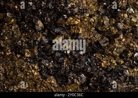 Pyrite mineral flower black and golden color soft focus close up, abstract pattern structure Stock Photo