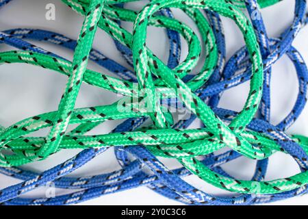 Tangled blue and green strings on white background with empty space ...