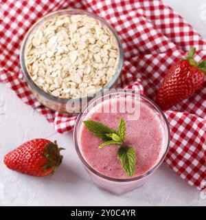 Strawberry milkshake or smoothie with oatmeal in a glass, top view copy space Stock Photo