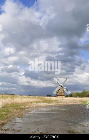 Dutch windmill bu river over beautiful sky, Netherlands Stock Photo