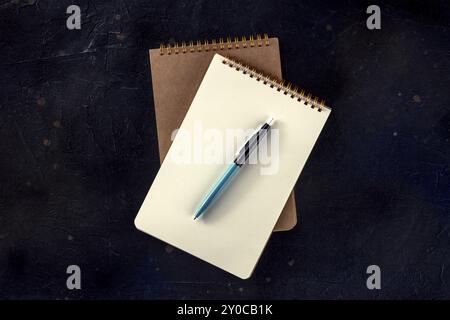 Notebook mockup with a pen, overhead flat lay shot on a black desk, Food photography Stock Photo