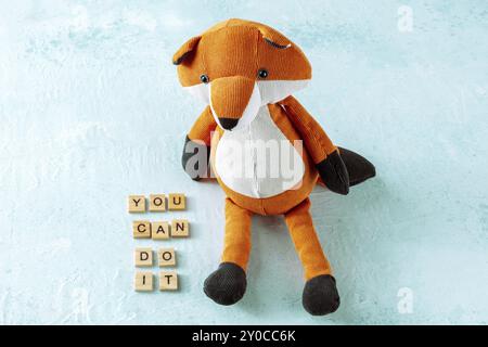 You can do it, motivational banner with letters and a toy fox on a blue background, Food photography, Food photography Stock Photo