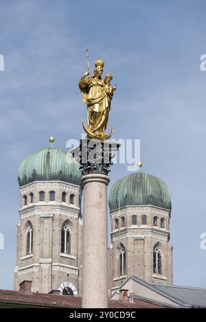 Golden statue of the Virgin Mary in front of the New Town Hall, behind it onion domes of the Church of Our Lady, Munich, Bavaria, Germany, Europe Stock Photo