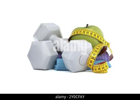 Fitness and health supplies, such as a green apple with a tape measure wrapped around it and two gray dumbbells isolated on white background Stock Photo