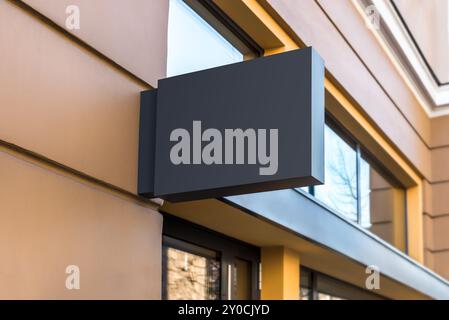 Blank Mockup Of Cafe Black Signboard On A Yellow Wall Stock Photo