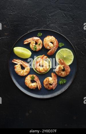 Shrimps, shot from the top on a black background. Cooked shrimp with lime, spicy seafood dish, Food photography, Food photography Stock Photo