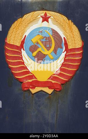 Soviet emblem featuring hammer and sickle over a globe, surrounded by wheat and topped with a red star, Crest on bow of Russian Icebreaker Kapitan Khl Stock Photo