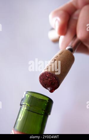 A hand opening a bottle of wine Stock Photo