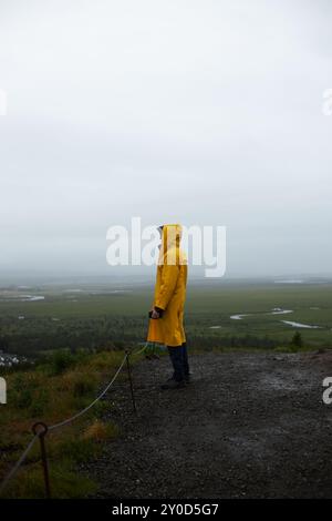 Icelandic landscape, person in yellow rain jacket. Landmannalaugar, Iceland. Stock Photo