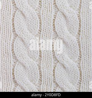 Texture of white knitted woolen fabric for wallpaper and an abstract background Stock Photo