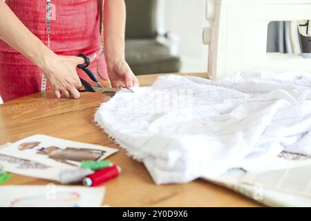 Fashion designer woman working on her designs in the studio. Close up Stock Photo