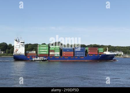 Feeder ship Energizer with pilot boat on the Elbe entering the harbour of Hamburg, Germany, Europe Stock Photo