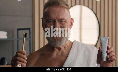 Portrait close up indoors smiling old man bearded grandpa healthy toothy smile looking at camera happy senior male retired mature pensioner in Stock Photo