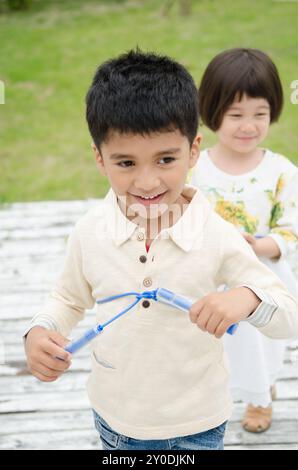 Children playing with train games with jump rope Stock Photo