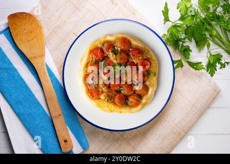 Savory tarte tatin with cherry tomatoes. Top view table with christmas decoration. Stock Photo