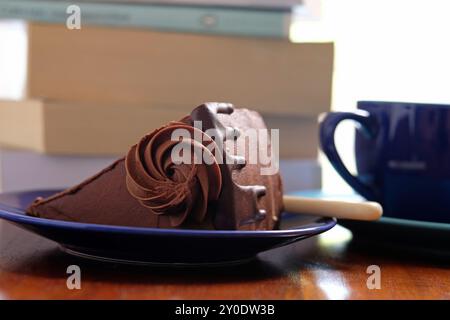 slice of delicious chocolate cake on blue plate Stock Photo