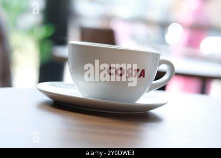 costa coffee cup and saucer on blurred background Stock Photo