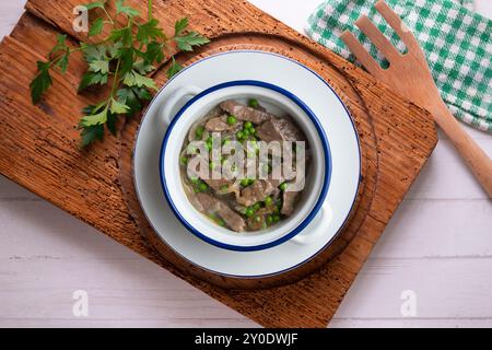 Strips of beef cooked with onion and peas. Top view table with decoration. Stock Photo