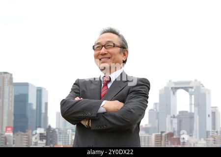 A senior businessman with his arms crossed Stock Photo