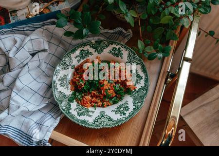 Delicious rice dish served in an ornate green-patterned plate on Stock Photo