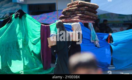 Gaza, Palestine. 20 October 2023. Tents have been set up next to an UNRWA school in Deir al Balah, to be used as shelter by displaced Palestinians during the ongoing Israeli military offensive in Gaza. The Gaza Strip has been under heavy bombardment for the 14th consecutive day, with a large number of displaced Palestinians struggling to find safety in the besieged and overcrowded tiny Palestinian enclave Stock Photo