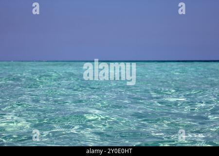 Empty sea beach, view to azure water surface and blue sky Stock Photo