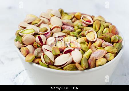 Assorted Pistachios In A Simple White Bowl Stock Photo