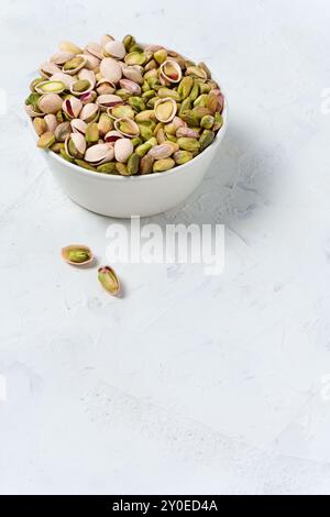 Assorted Pistachios In A Simple White Bowl Stock Photo