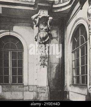 Vintage photo of Dresden. Japanese palace (Japanisches Palais) in Dresden, Herme in the courtyard. Germany. 1903 The northern courtyard façade is of the simplest design in the style of the main façade. The other three show a gallery on the ground floor, which is supported by six herms on the sides and twelve on the south front. These are depicted as colossal Japanese figures in fantastic costumes, often with pointed hats and open robes so that their fat chests and bloated bodies peek out; at the bottom are all kinds of utensils, musical instruments, trays and the like. Between the herms on the Stock Photo