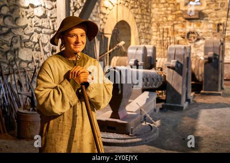 Ferrón, Blacksmiths dressed in work clothes, Forging hammer, Ferrería de Mirandaola, Mirandaola Ironworks, Legazpi, Gipuzkoa, Basque Country, Spain. Stock Photo