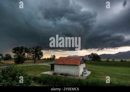 Dark and spectacular storm clouds over a barn, summer, Schlehdorf, Bavaria, Germany, Europe Stock Photo