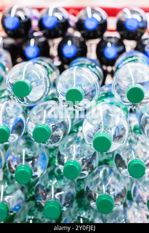 Refreshing assortment of soda and cola in large PET bottles, artfully stacked on their sides Stock Photo